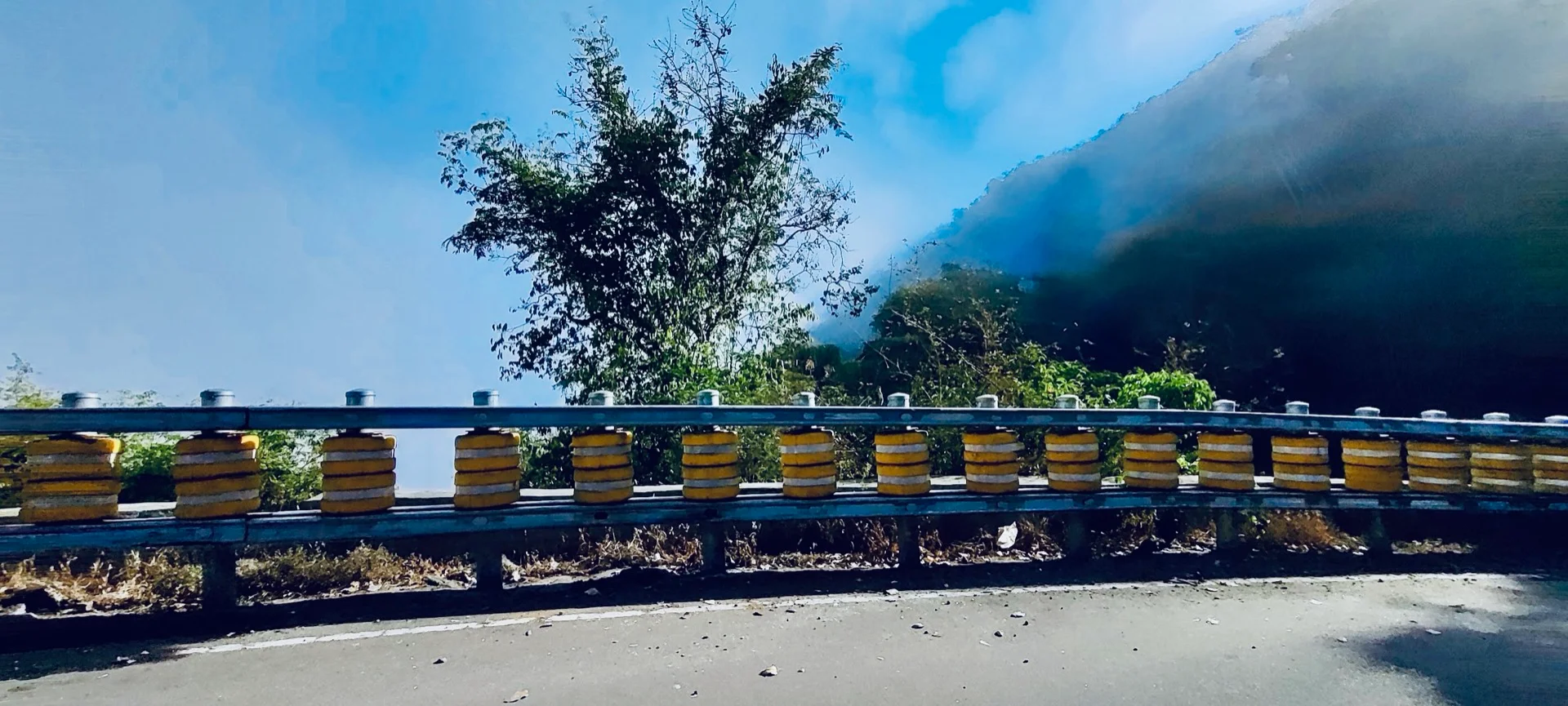 Steep curves with yellow crash barriers on Masinagudi Ghat road